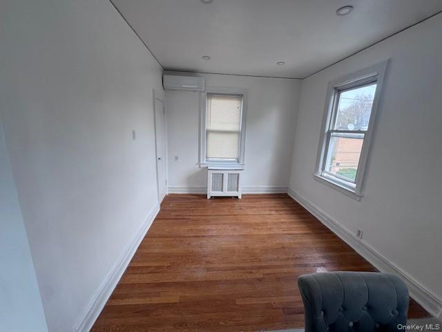 530 Fourth Avenue, Unit 2 Pelham, NY 10803 - Photo 4 of 8 a view of an empty room with wooden floor and a window