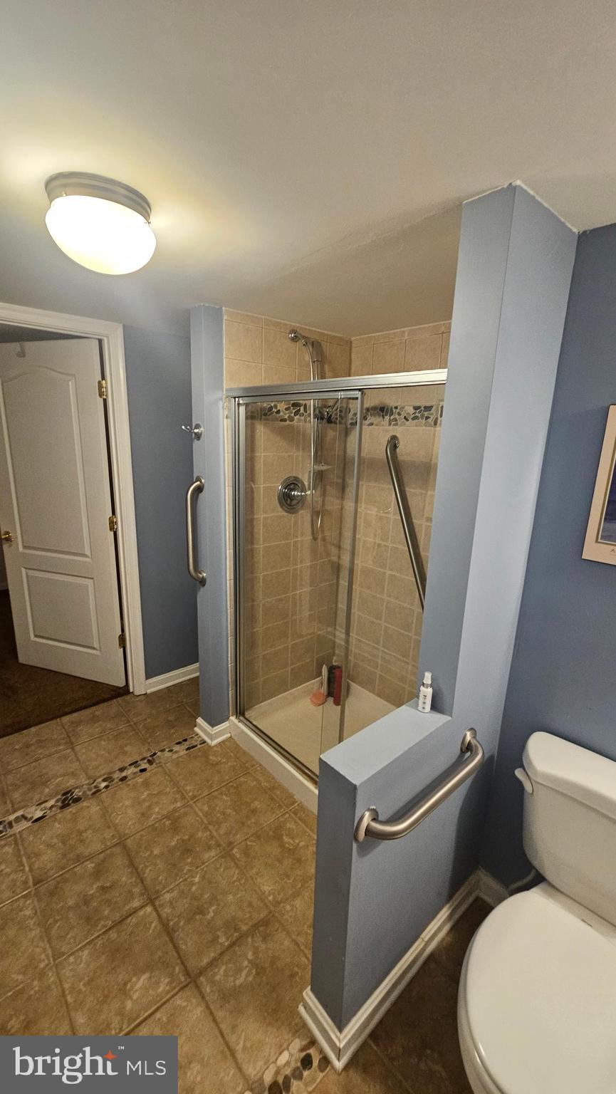 6107 Traceys Overlook Road Tracys Landing, MD 20779 - Photo 45 of 67 a bathroom with a sink a toilet and shower