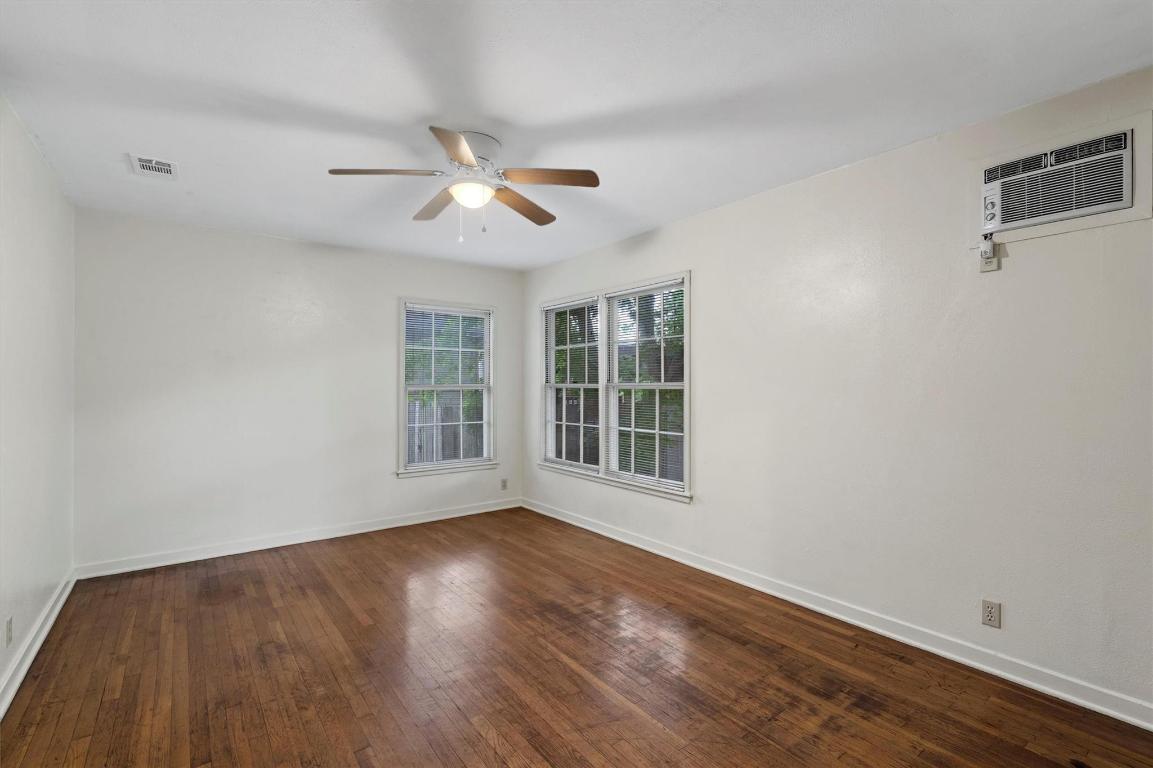 1511 Alguno Road Austin, TX 78757 - Photo 11 of 25 a view of empty room with wooden floor and fan