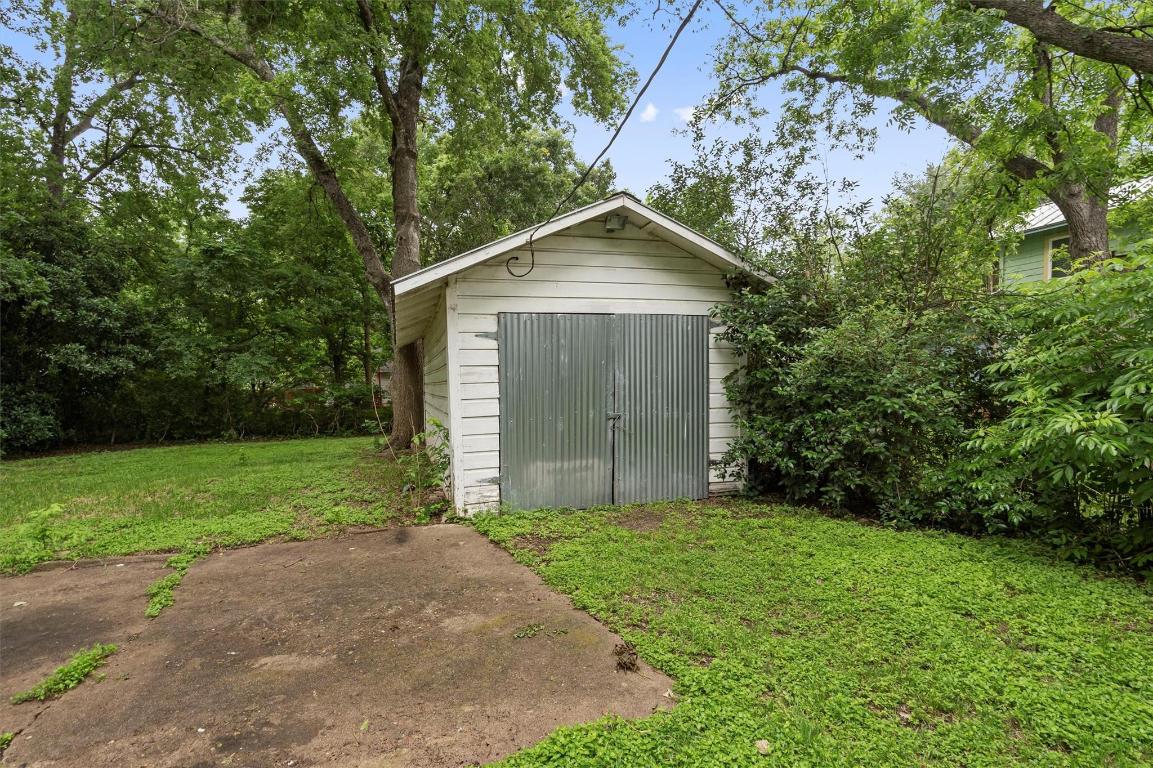 1511 Alguno Road Austin, TX 78757 - Photo 16 of 25 a front view of house with yard and trees all around