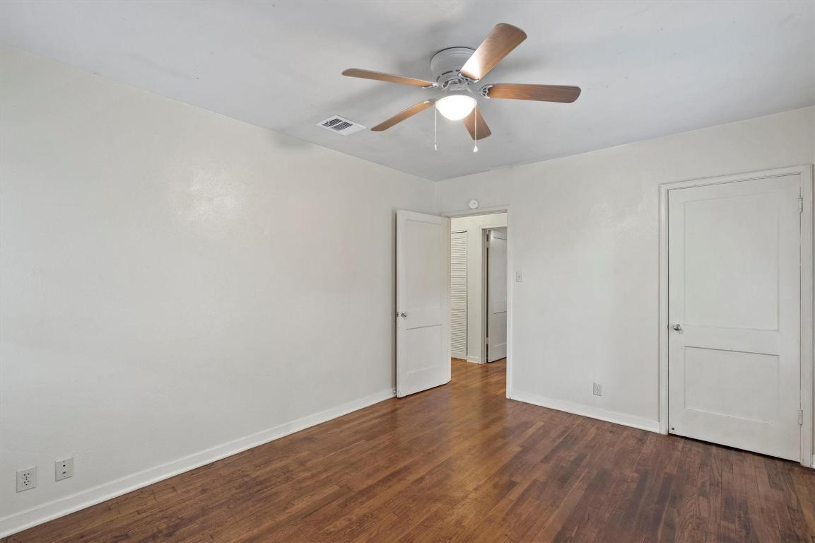 1511 Alguno Road Austin, TX 78757 - Photo 8 of 25 an empty room with wooden floor and windows