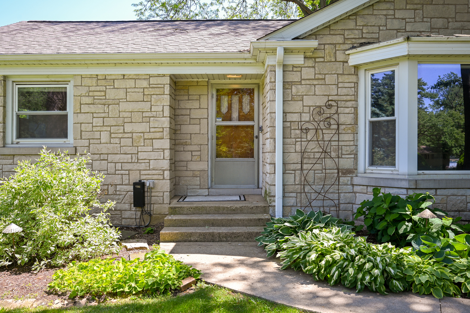 325 South Lambert Road Glen Ellyn, IL 60137 - Photo 2 of 32 a front view of a house with a garden