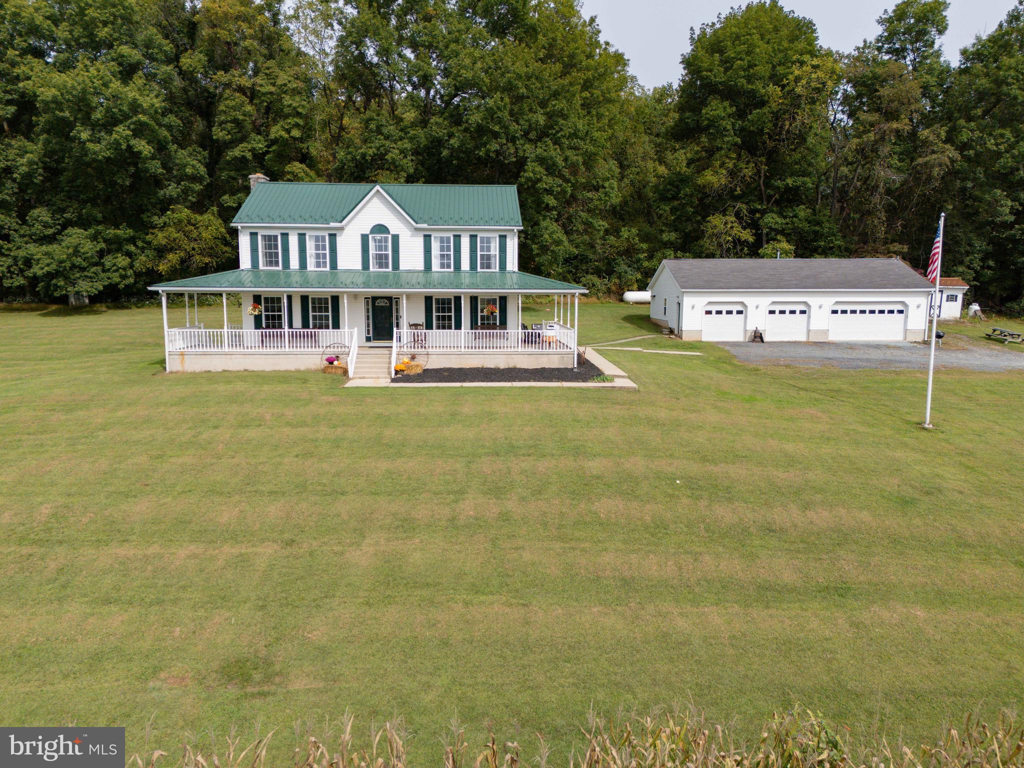 a front view of a house with swimming pool having outdoor seating
