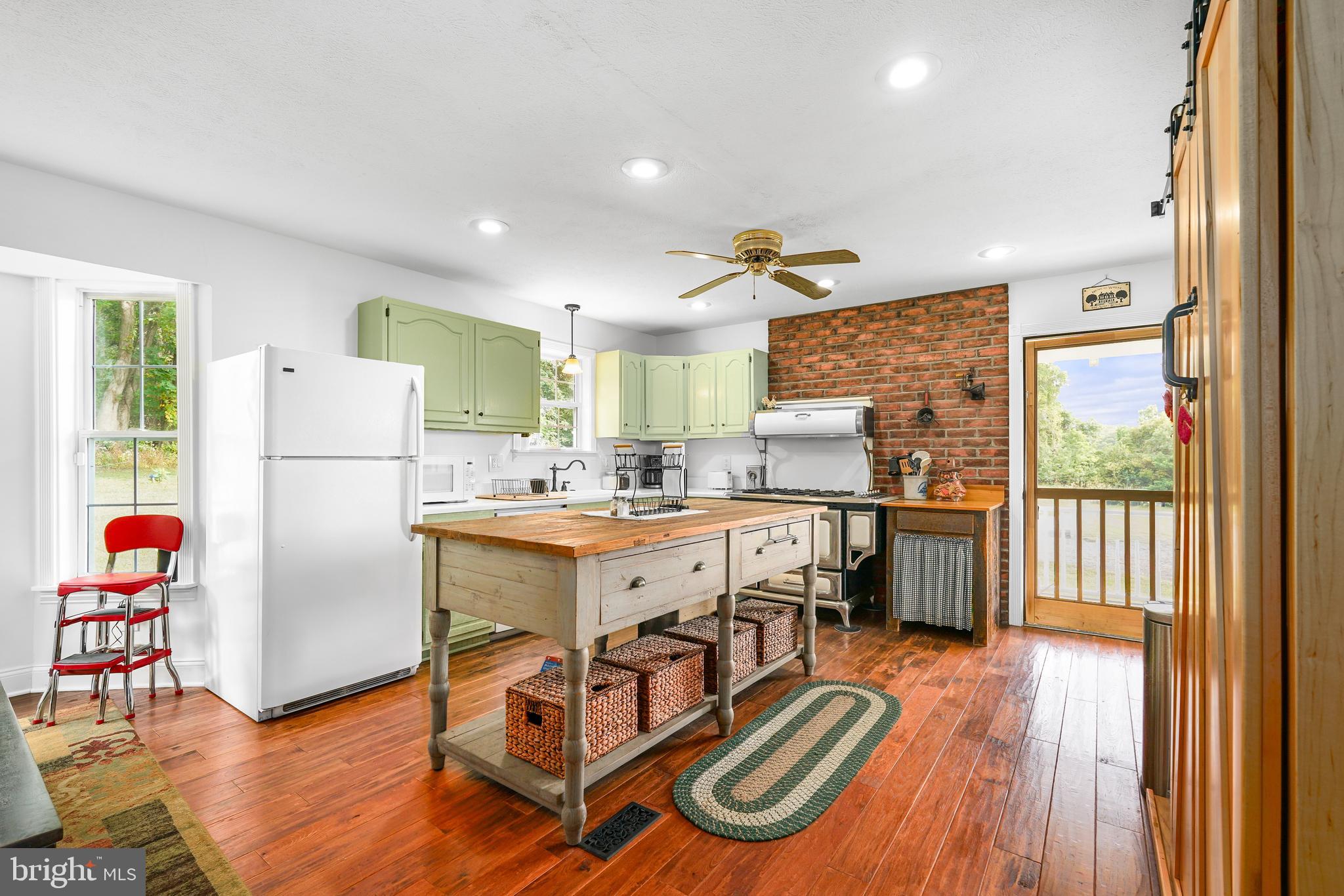 424 Springhill Road Rising Sun, MD 21911 - Photo 24 of 42 a kitchen with stainless steel appliances granite countertop a refrigerator a oven a sink dishwasher and white cabinets with wooden floor