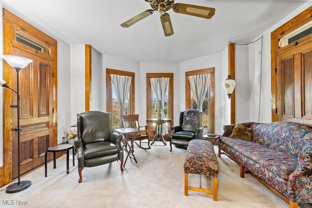 13642 Navarre Road Southwest Beach City, OH 44608 - Photo 6 of 33 Living room with ceiling fan and light colored carpet