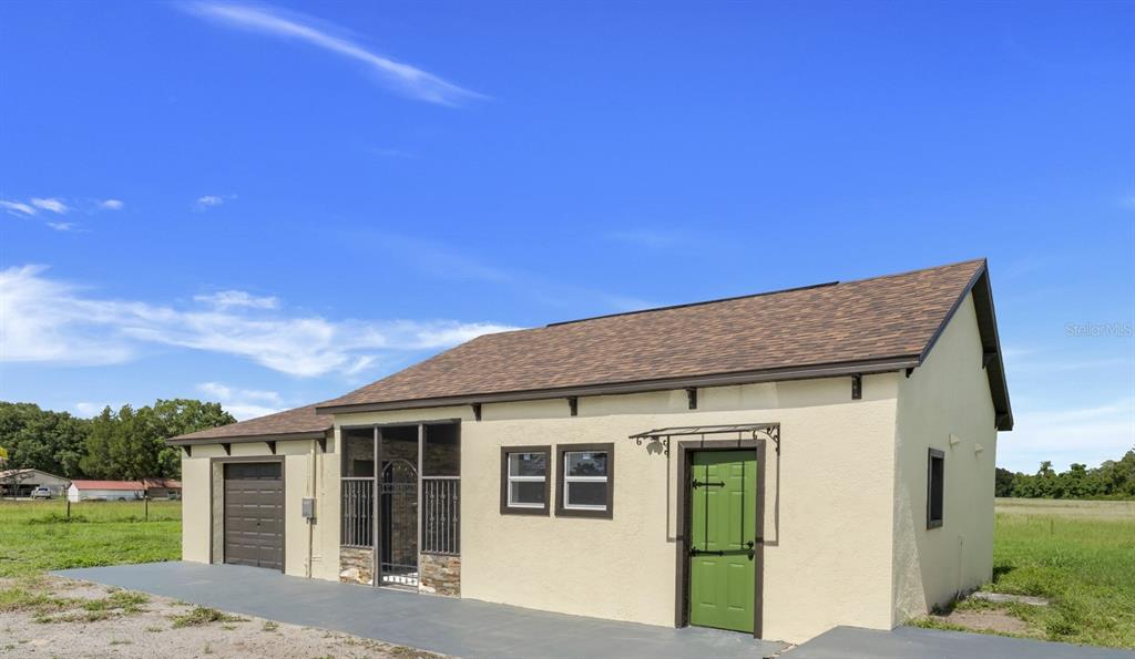 13832 South Bay Lake Road Groveland, FL 34736 - Photo 11 of 55 a front view of a house with a garden