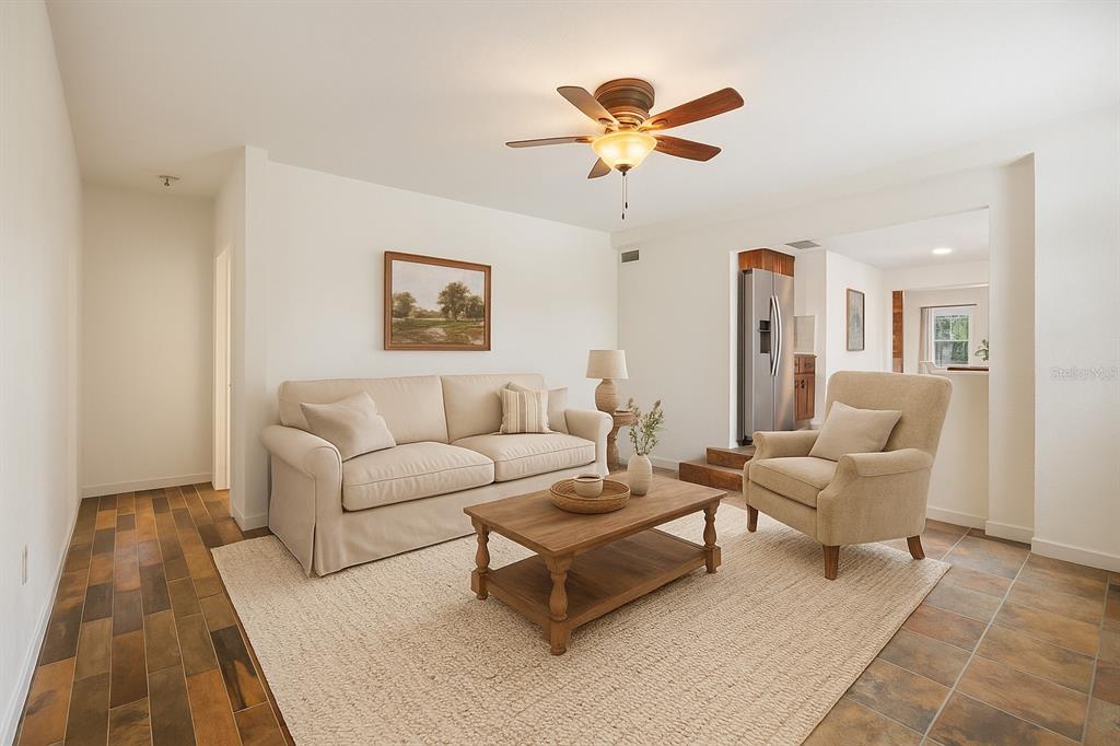 13832 South Bay Lake Road Groveland, FL 34736 - Photo 2 of 55 a living room with furniture and a chandelier