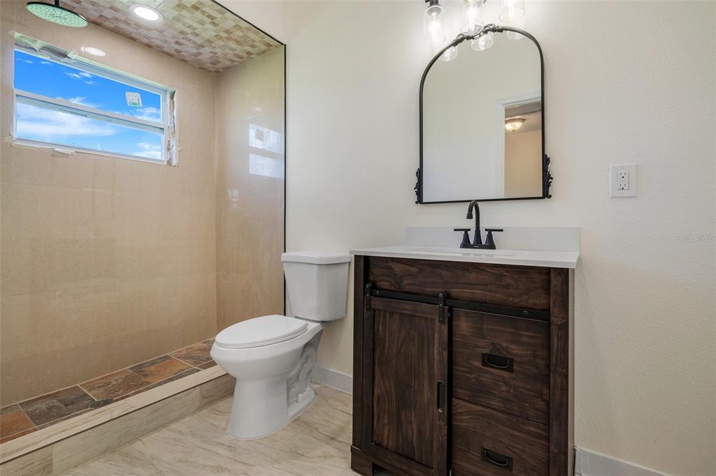 13832 South Bay Lake Road Groveland, FL 34736 - Photo 23 of 55 a bathroom with a toilet sink and mirror