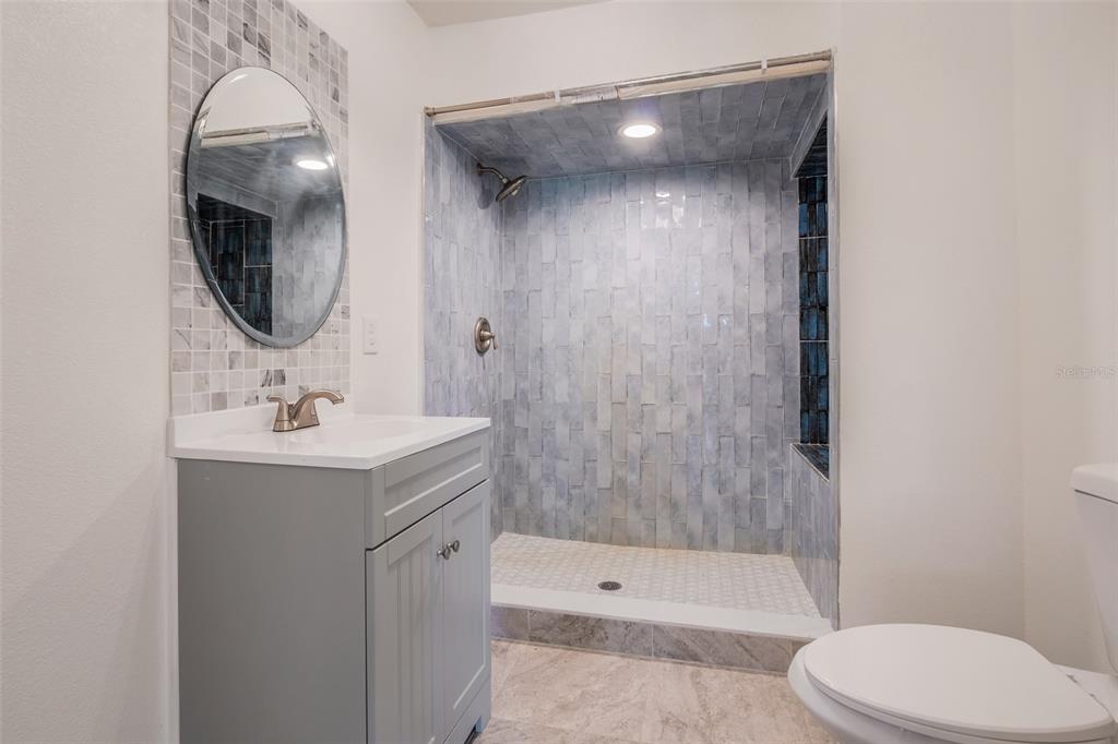 13832 South Bay Lake Road Groveland, FL 34736 - Photo 25 of 55 a bathroom with a sink a toilet and shower