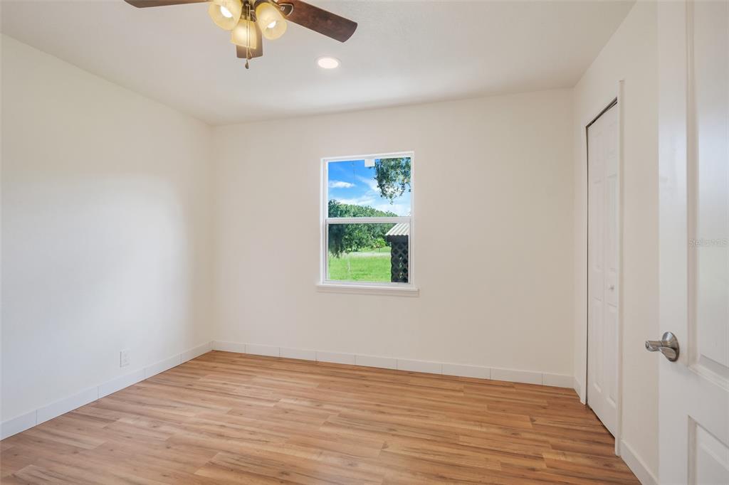13832 South Bay Lake Road Groveland, FL 34736 - Photo 26 of 55 wooden floor in an empty room with a window