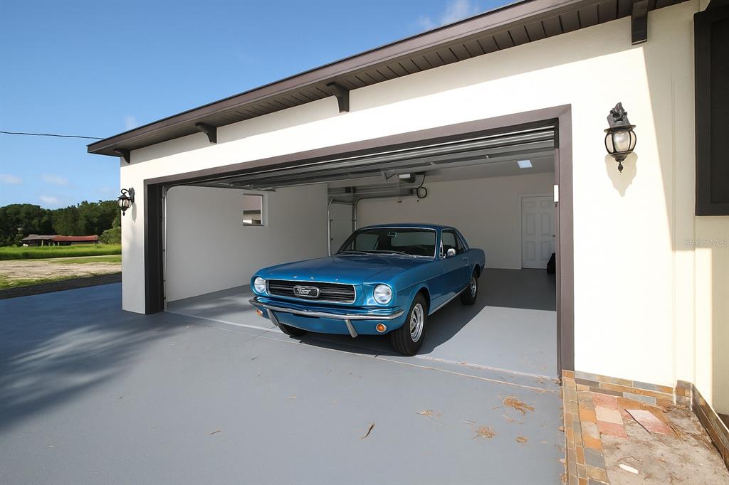 13832 South Bay Lake Road Groveland, FL 34736 - Photo 37 of 55 a car parked in garage