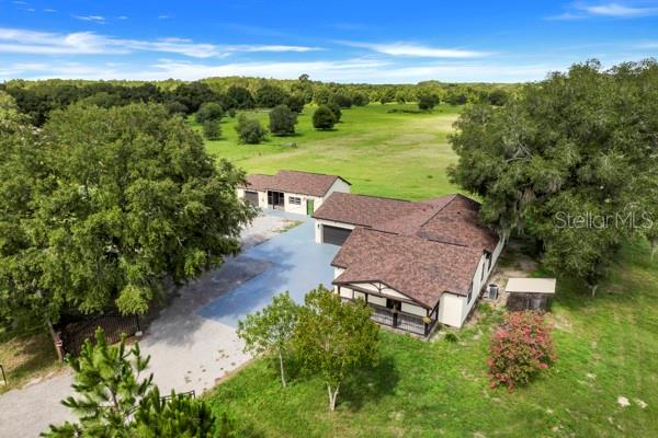 13832 South Bay Lake Road Groveland, FL 34736 - Photo 44 of 55 an aerial view of a house with garden