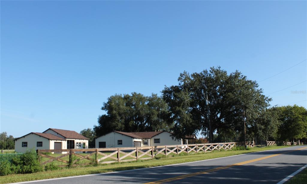 13832 South Bay Lake Road Groveland, FL 34736 - Photo 46 of 55 a front view of a house with a yard and garage