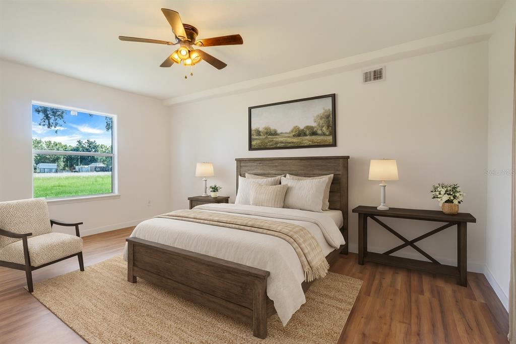 13832 South Bay Lake Road Groveland, FL 34736 - Photo 9 of 55 a bedroom with bed and window