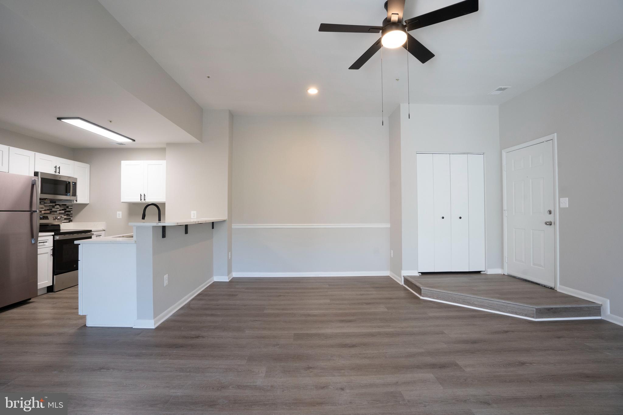 30 I Greystone Court, Unit I Annapolis, MD 21403 - Photo 8 of 15 a view of empty room with wooden floor and ceiling fan