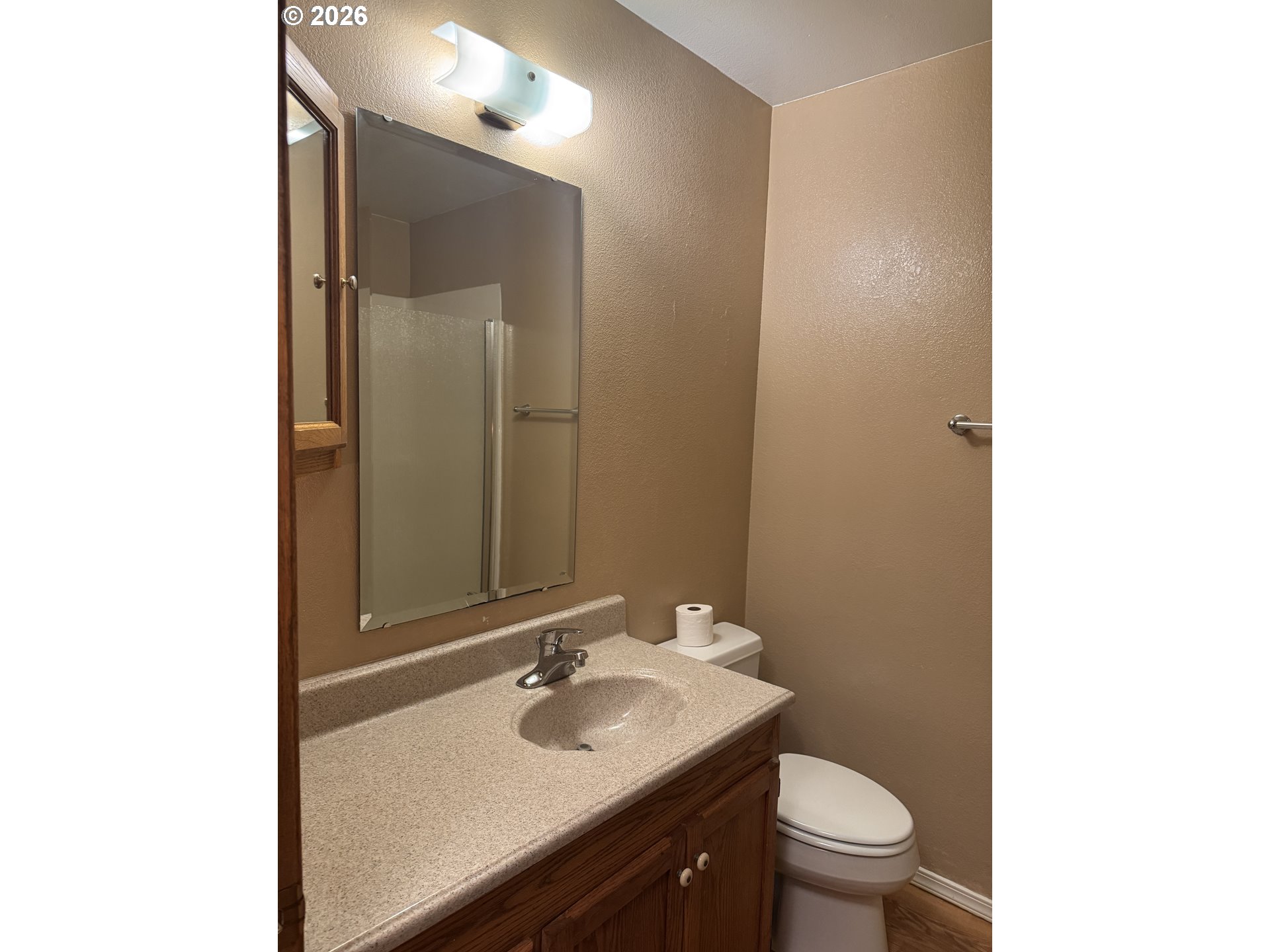 870 12th Street Southwest Bandon, OR 97411 - Photo 13 of 25 a bathroom with a sink toilet and mirror