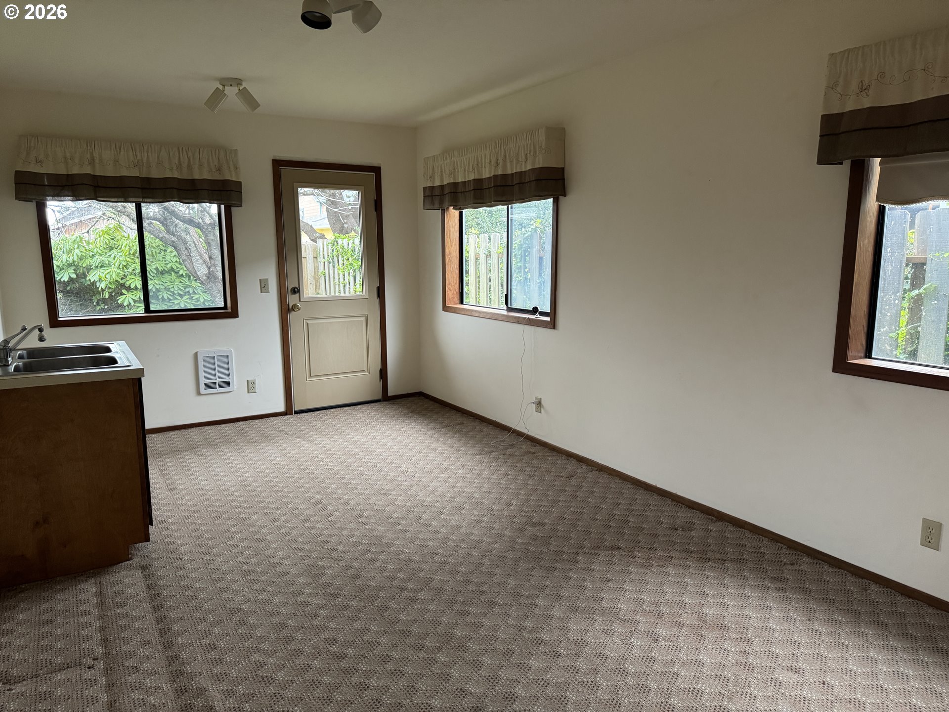 870 12th Street Southwest Bandon, OR 97411 - Photo 17 of 25 a view of an empty room with a window