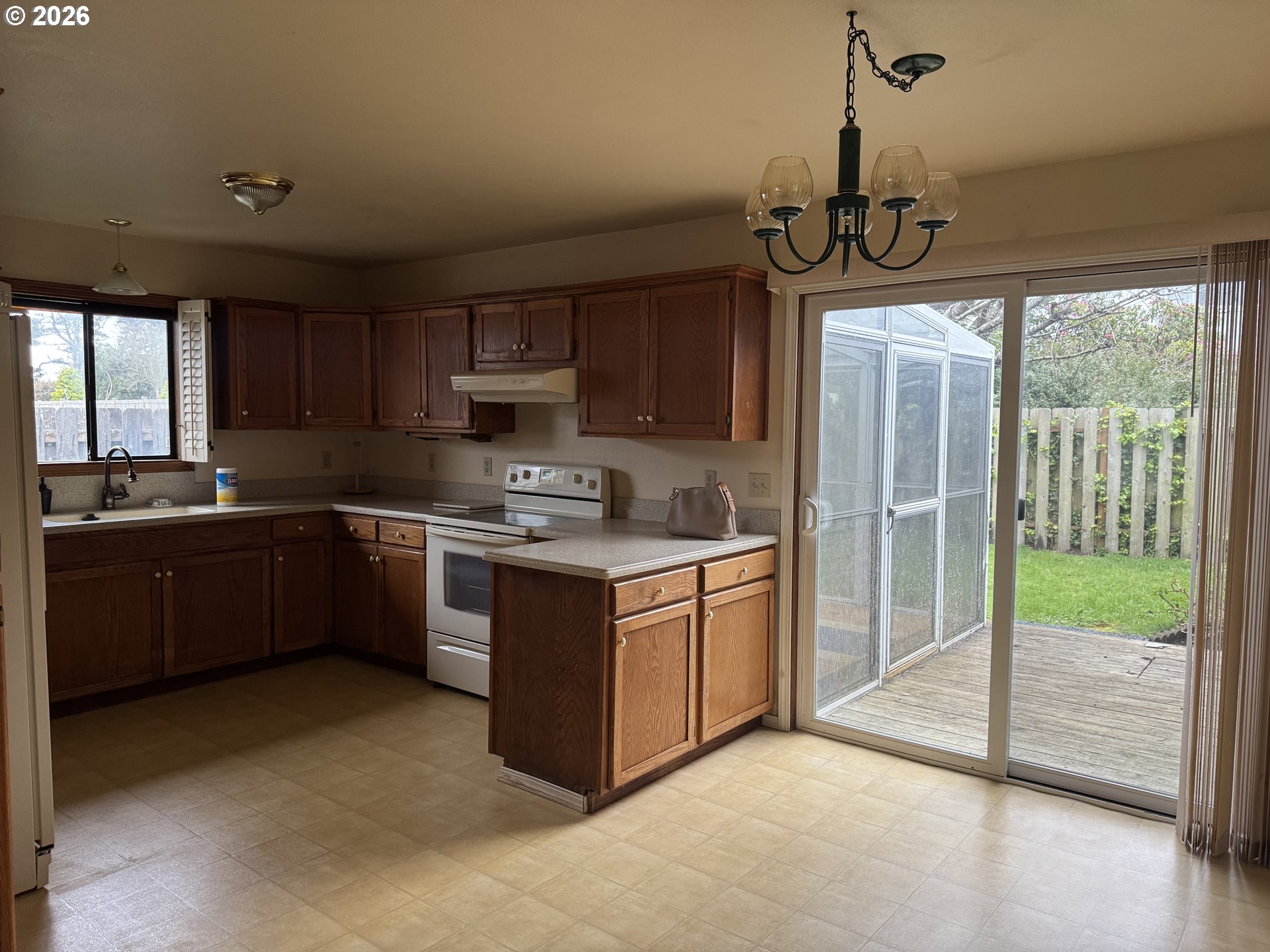 870 12th Street Southwest Bandon, OR 97411 - Photo 4 of 25 a kitchen with stainless steel appliances granite countertop a stove a sink and a refrigerator with wooden floor