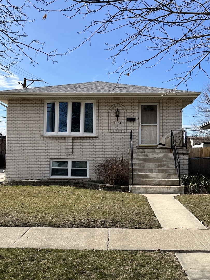 11034 Major Avenue Chicago Ridge, IL 60415 - Photo 1 of 6 a front view of a house with garden