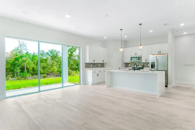 a view of kitchen with kitchen island and windows