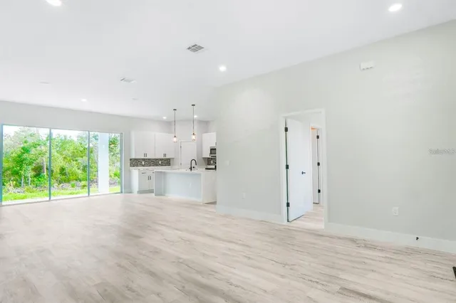 a view of a kitchen with a sink and a window