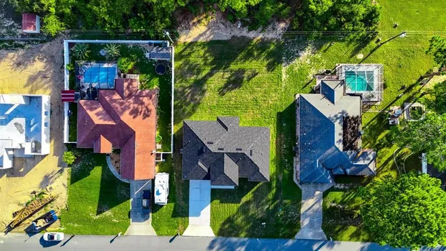 an aerial view of houses with yard