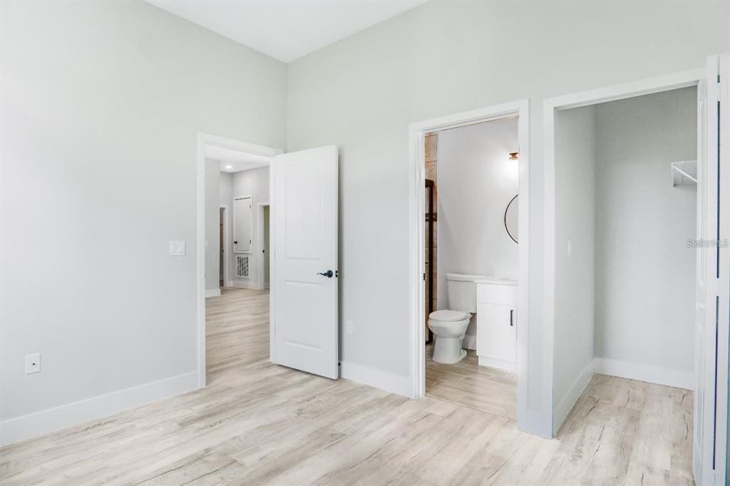 4540 Southwest 170th Street Road Ocala, FL 34473 - Photo 21 of 34 a view of a room with wooden floor and a bathroom