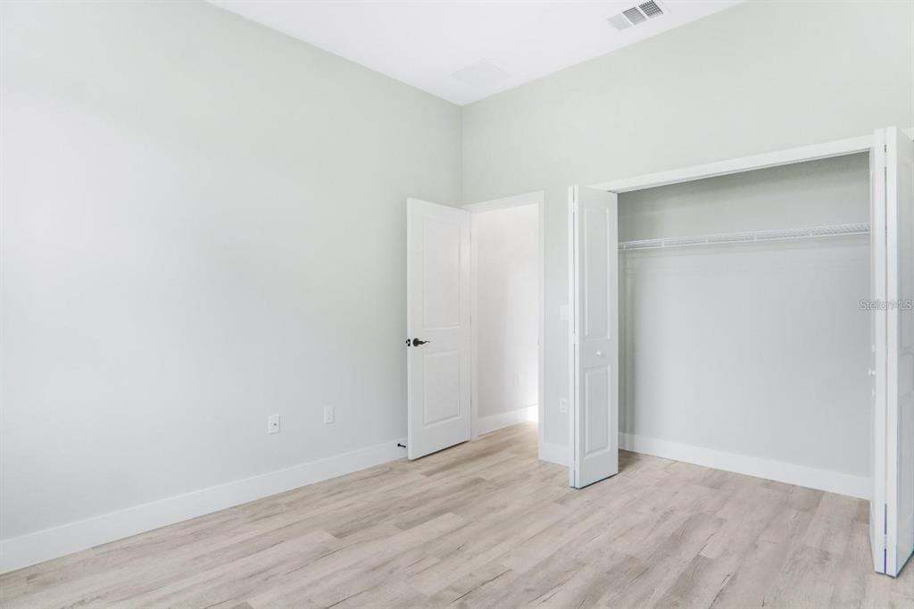 4540 Southwest 170th Street Road Ocala, FL 34473 - Photo 26 of 34 an empty room with wooden floor and closet