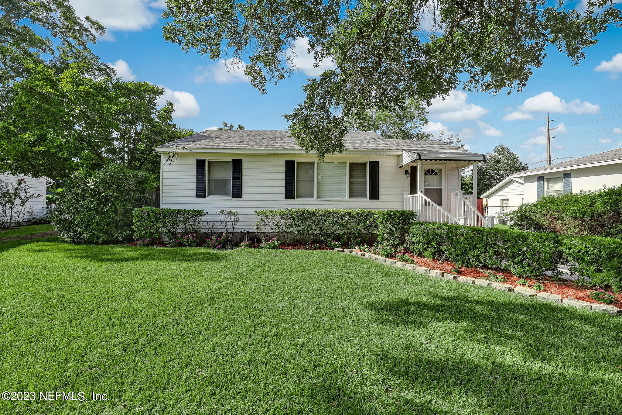 4511 Cambridge Road Jacksonville, FL 32210 - Photo 3 of 30 a front view of a house with a garden
