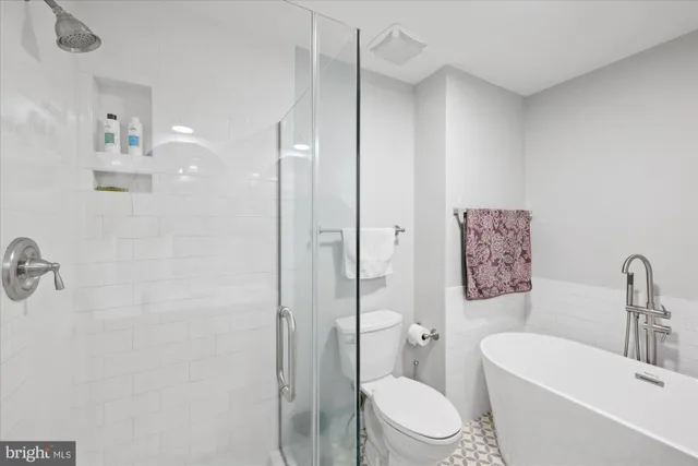 a white toilet sitting next to a bathroom sink