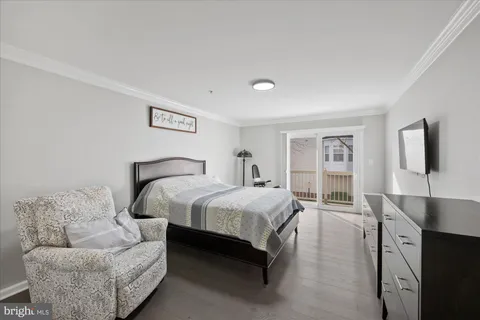 a spacious bedroom with a bed and couch