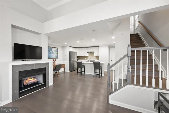 a living room with furniture fireplace and flat screen tv