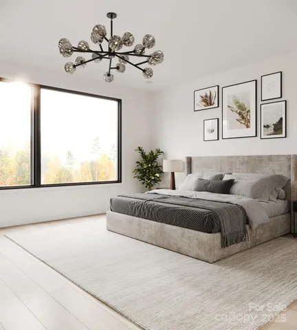 a spacious bedroom with a large bed and a chandelier