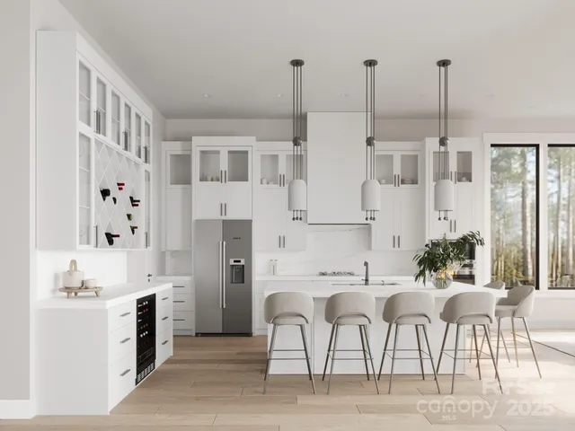 a kitchen with a table chairs sink and cabinets