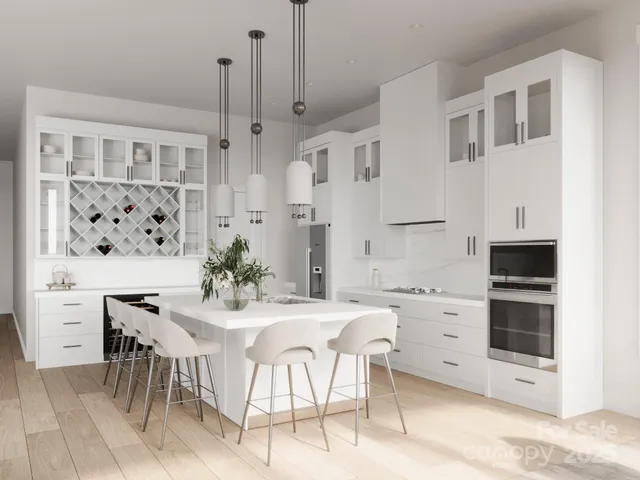 a kitchen with stainless steel appliances kitchen island granite countertop a table and chairs