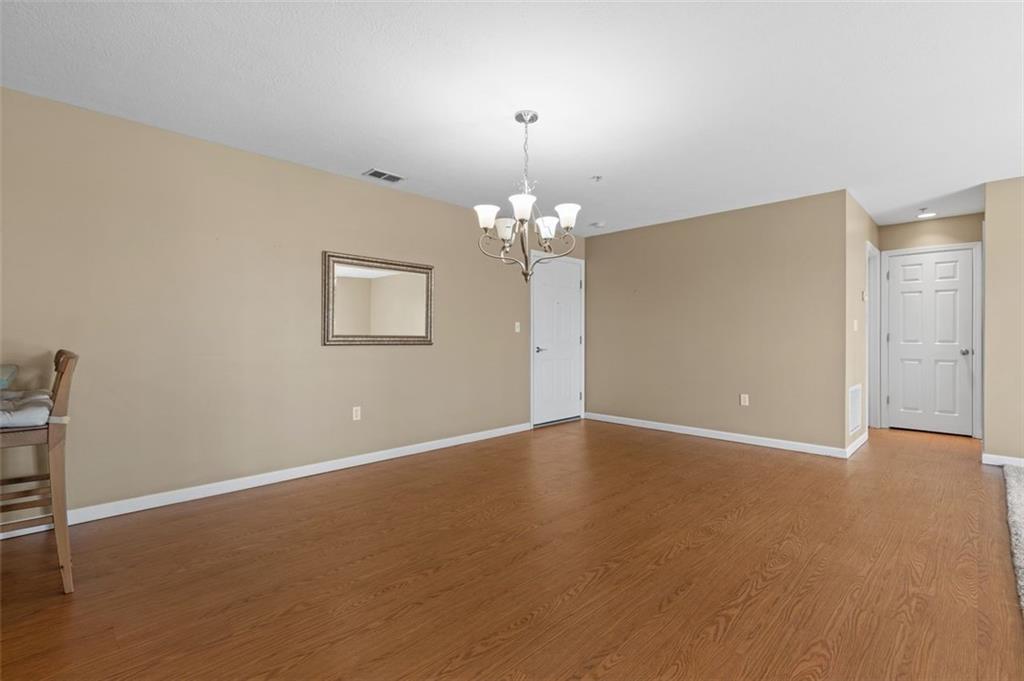 1 Coraopolis Road Coraopolis, PA 15108 - Photo 8 of 24 a view of an empty room with chandelier and wooden floor