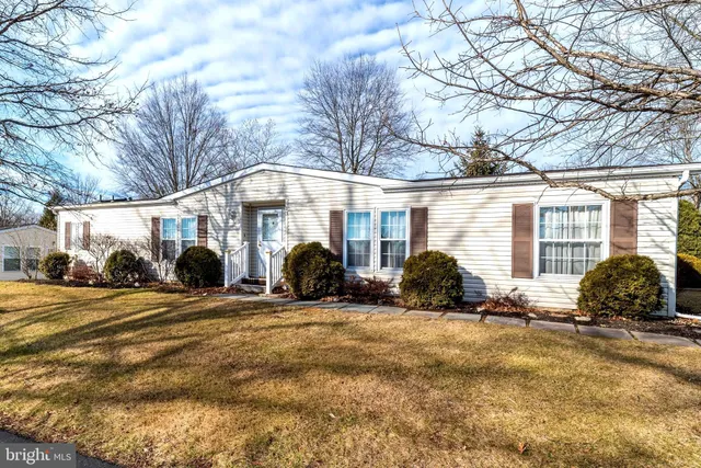 a view of a house with a yard covered in snow