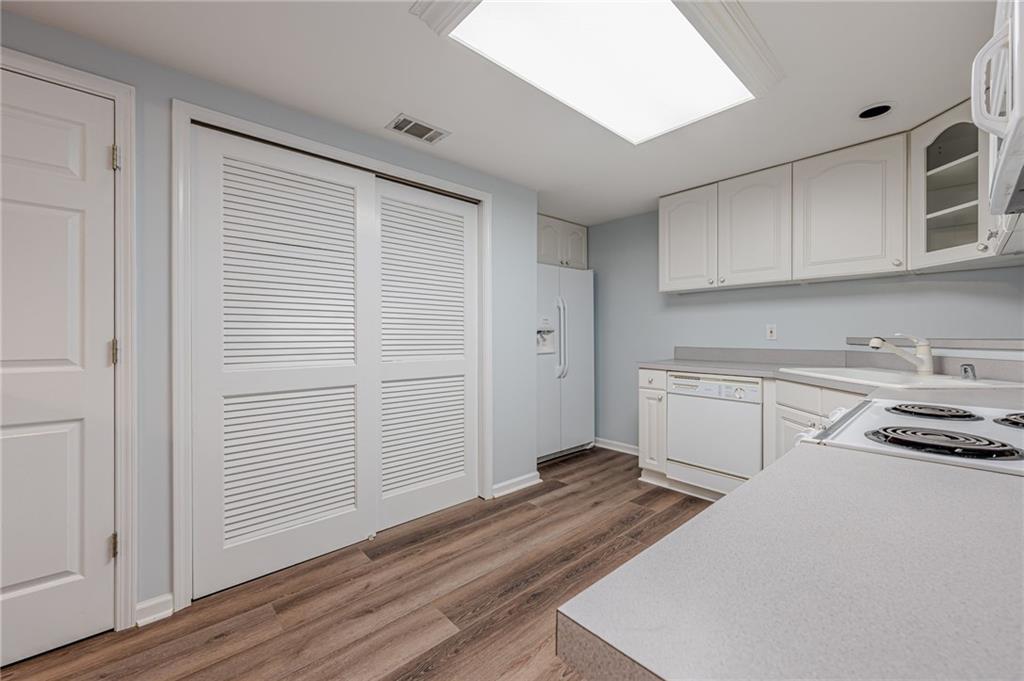 461 Braidwood Walk Northwest Acworth, GA 30101 - Photo 11 of 67 a kitchen with a refrigerator stove and white cabinets