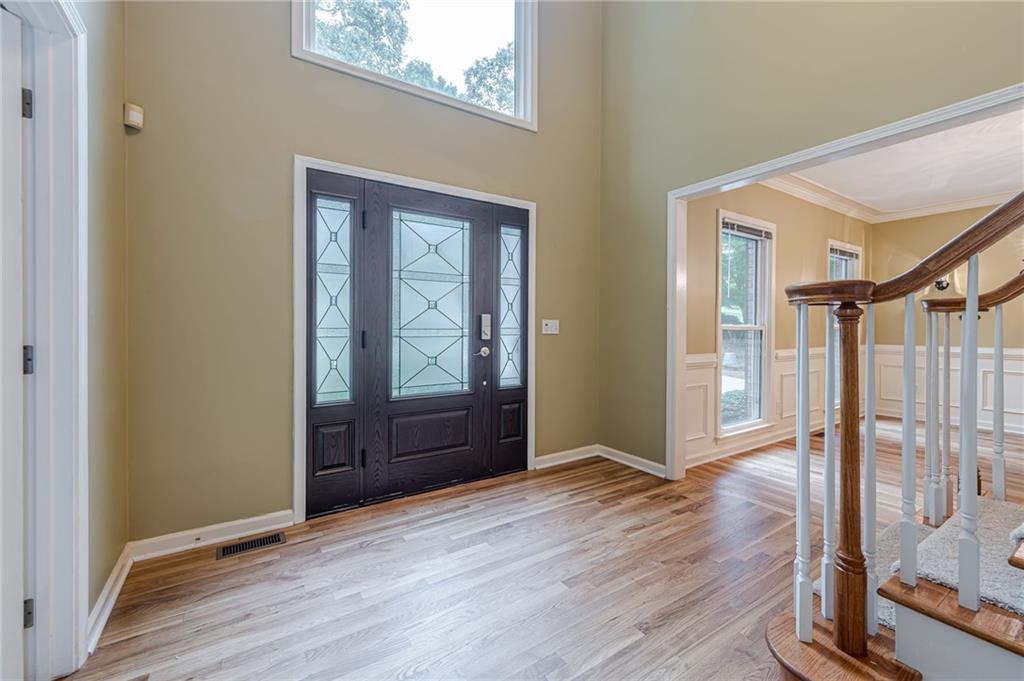 461 Braidwood Walk Northwest Acworth, GA 30101 - Photo 21 of 67 an empty room with wooden floor door and windows
