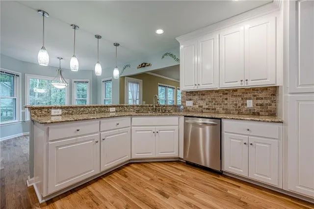 a kitchen with counter top space a sink and appliances
