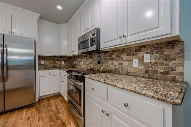 a view of a livingroom with wooden floor and a window