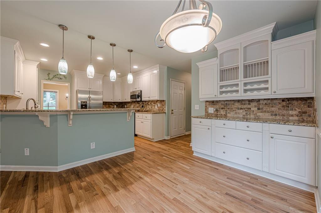 461 Braidwood Walk Northwest Acworth, GA 30101 - Photo 3 of 67 a kitchen with kitchen island a sink stainless steel appliances and cabinets