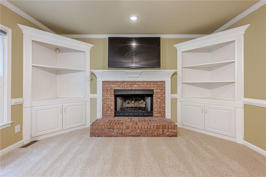 461 Braidwood Walk Northwest Acworth, GA 30101 - Photo 36 of 67 a living room with a fireplace and cabinets