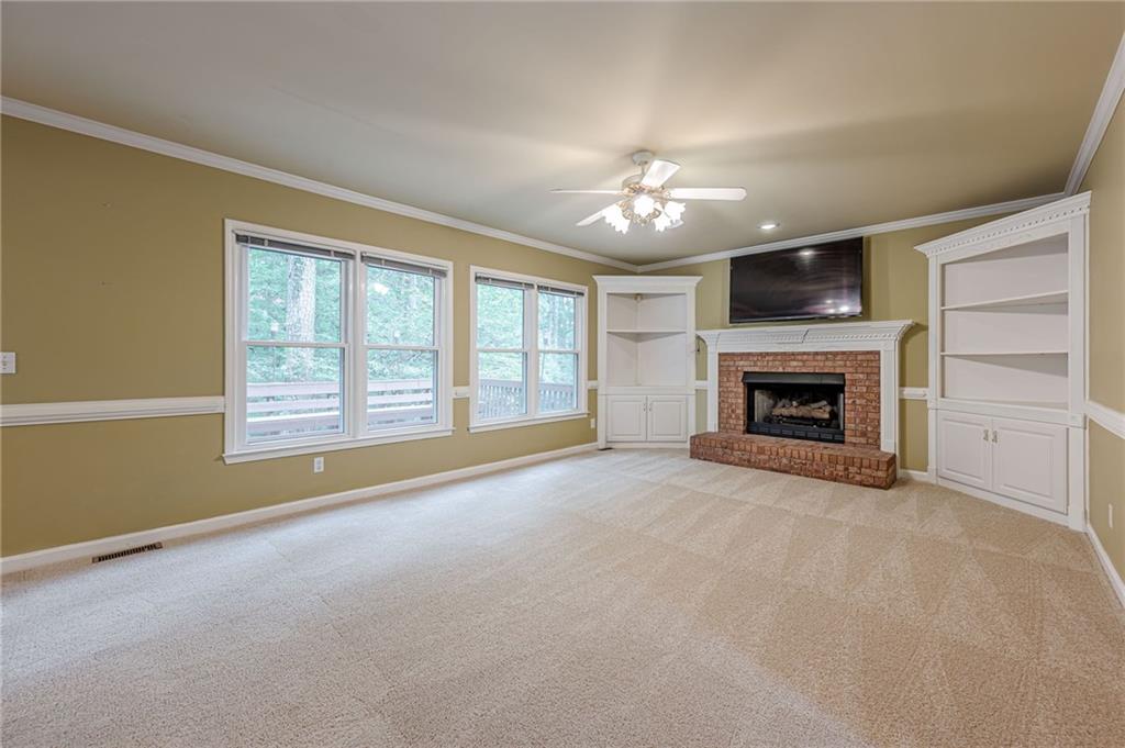 461 Braidwood Walk Northwest Acworth, GA 30101 - Photo 4 of 67 a view of an empty room with a fireplace and a window