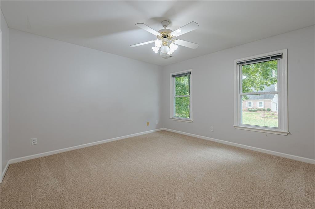 461 Braidwood Walk Northwest Acworth, GA 30101 - Photo 41 of 67 an empty room with windows and chandelier fan
