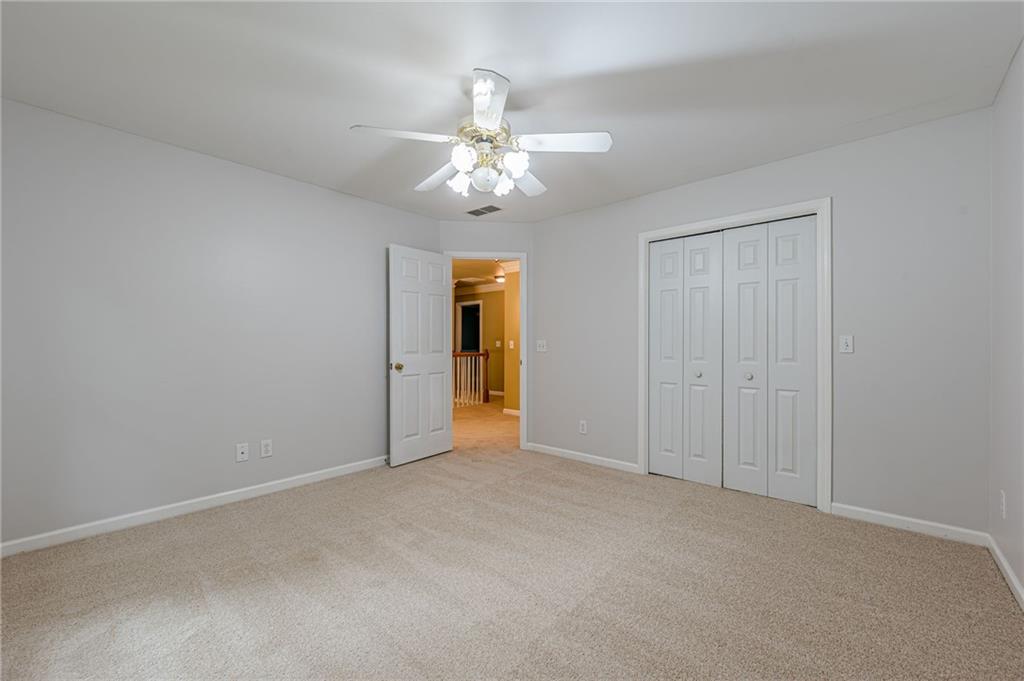 461 Braidwood Walk Northwest Acworth, GA 30101 - Photo 42 of 67 an empty room with closet and a ceiling fan