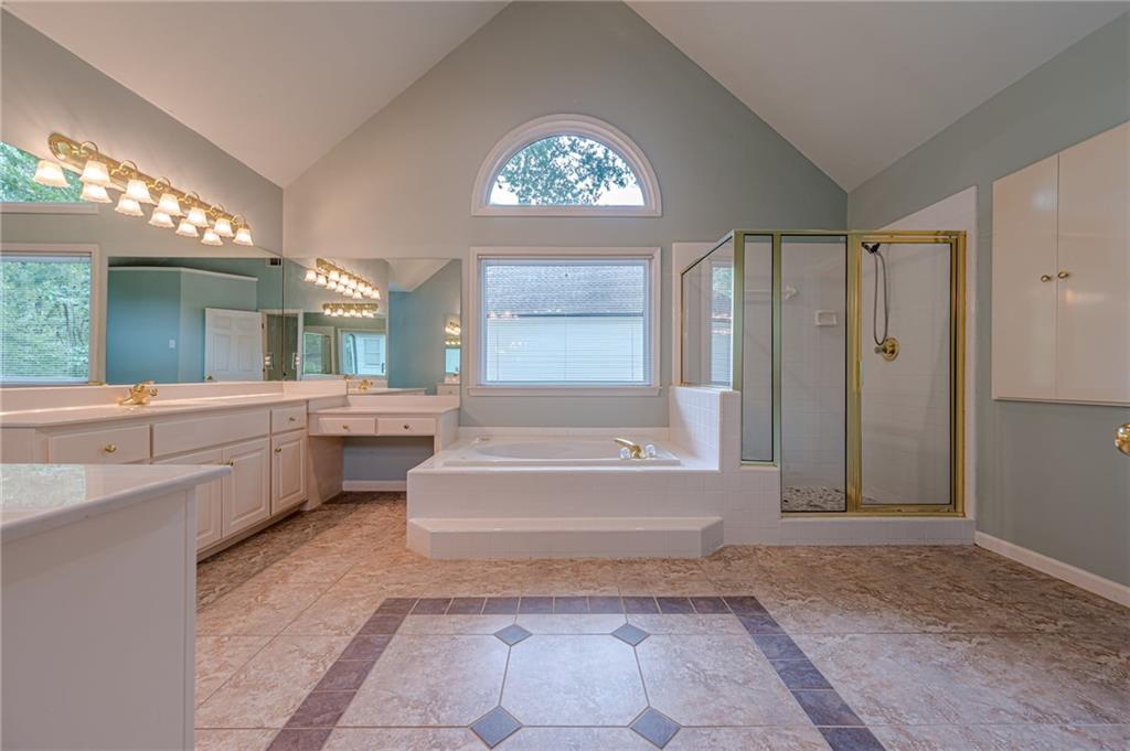 461 Braidwood Walk Northwest Acworth, GA 30101 - Photo 51 of 67 a spacious bathroom with a tub a sink and a large mirror
