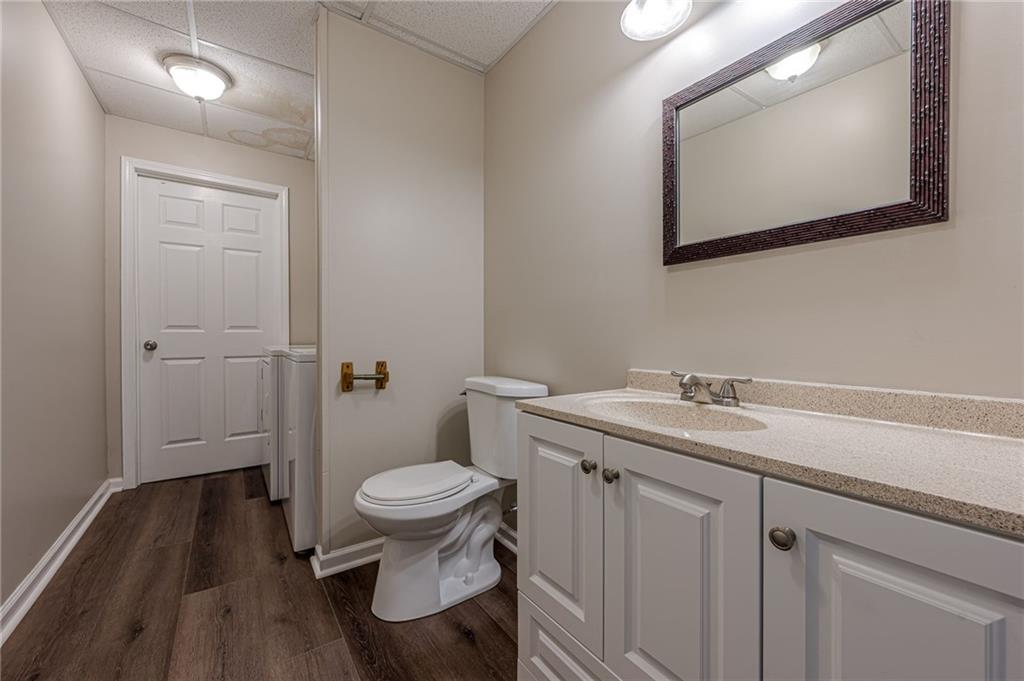 461 Braidwood Walk Northwest Acworth, GA 30101 - Photo 54 of 67 a bathroom with a granite countertop toilet sink and mirror