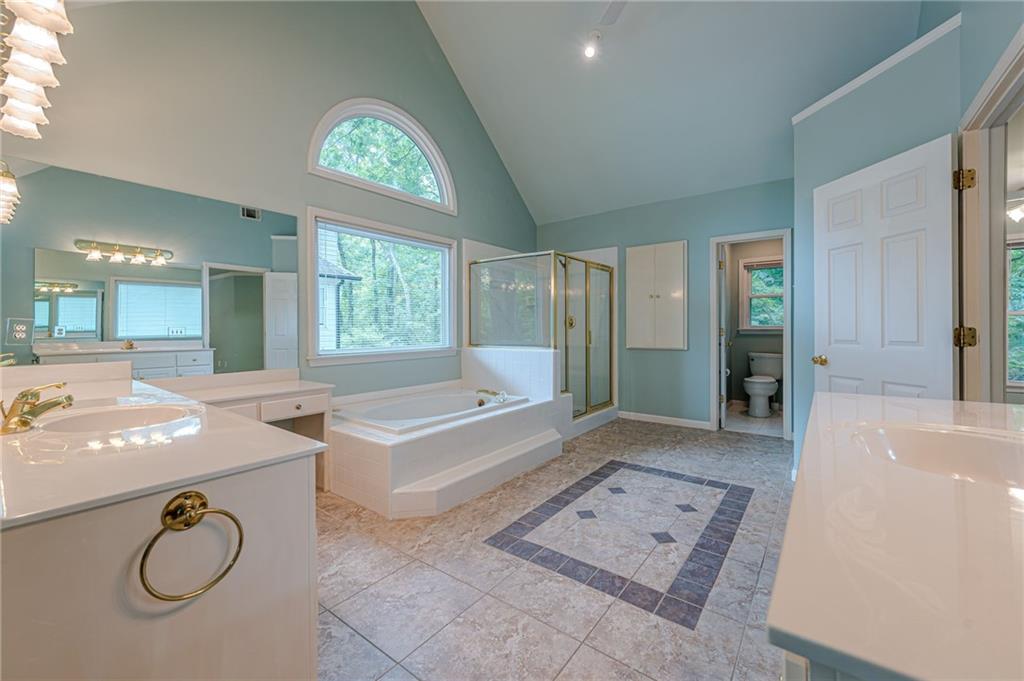 461 Braidwood Walk Northwest Acworth, GA 30101 - Photo 8 of 67 a spacious bathroom with a granite countertop tub sink and mirror