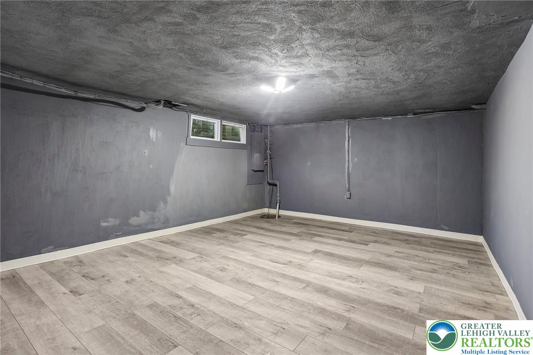 4008 Powell Road Brookhaven, PA 19015 - Photo 28 of 36 A well-maintained basement with wood flooring provides versatile additional living space.